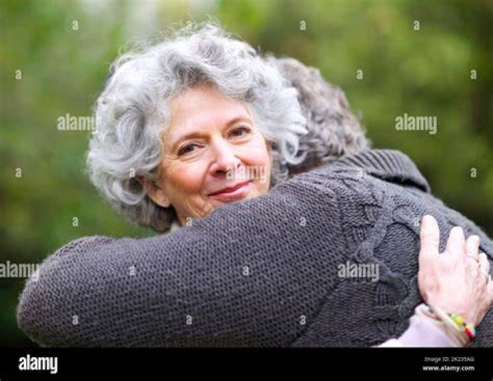 A woman lovingly embracing her mother-in-law | Source: Flickr