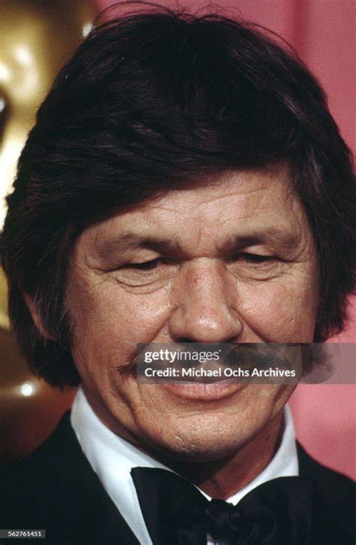 Actor Charles Bronson poses backstage after presenting "Best Supporting Actress" award during the 46th Academy Awards at Dorothy Chandler Pavilion in Los Angeles, California. | Source: Getty Images