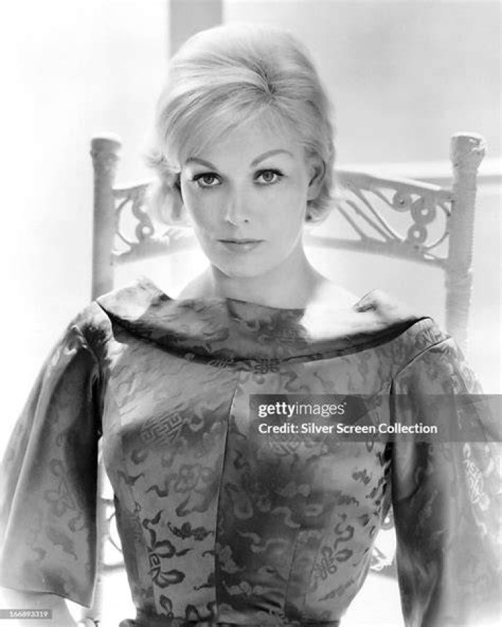 American actress Kim Novak kneeling on a tiger skin rug, circa 1955. | Source: Getty Images