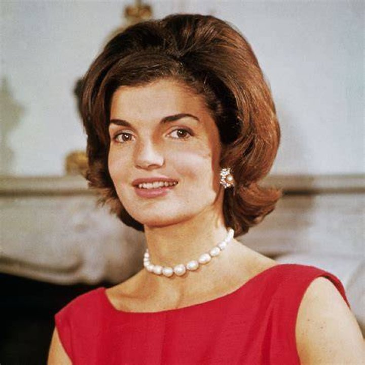 First Lady Jacqueline Kennedy poses for a photograph while holding a gift on December 12, 1961, in Washington D.C. | Source: Getty Images