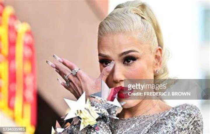 Gwen Stefani wipes tears from her eyes during her Hollywood Walk of Fame Star ceremony in Hollywood, California, on October 19, 2023. | Source: Getty Images