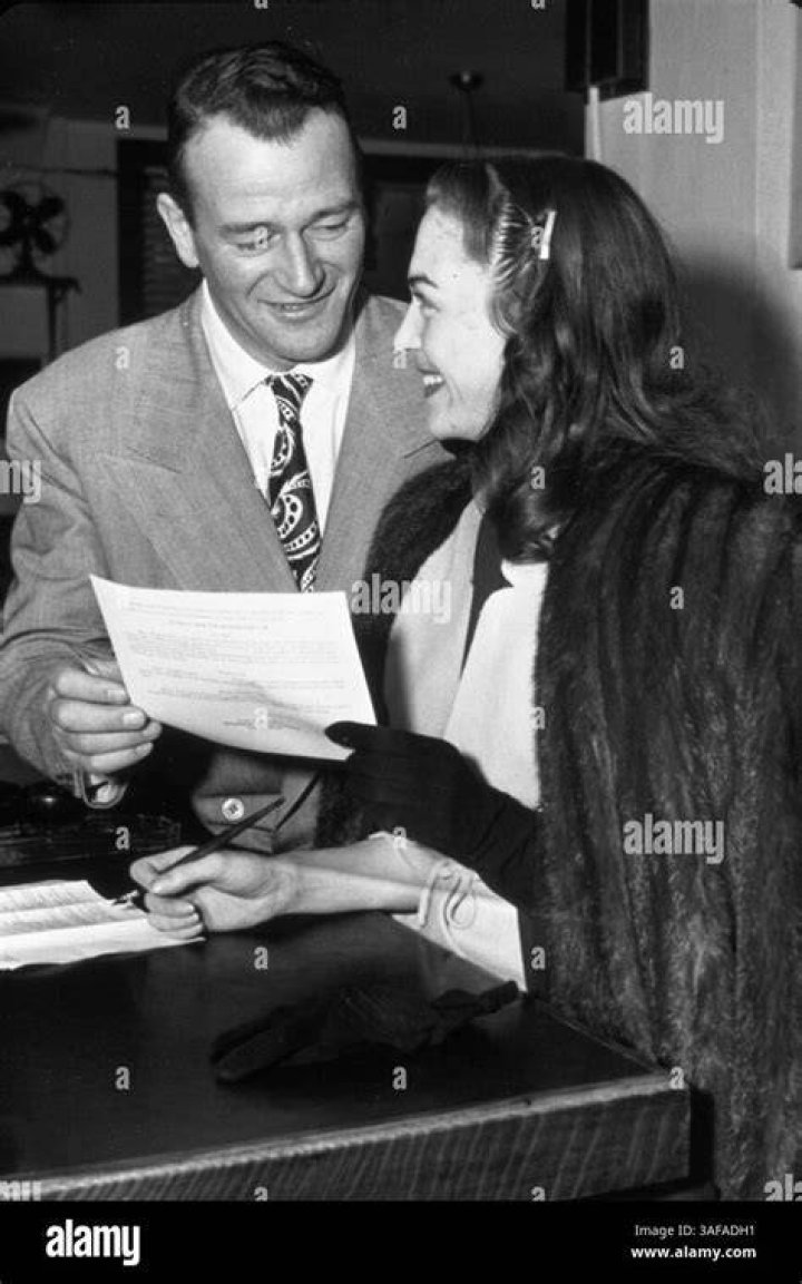John Wayne is pictured with his wife Josephine on their arrival last night at the new Hollywood Theater for the grand premiere of Cecil B. DeMille's latest epic | Source: Getty Images