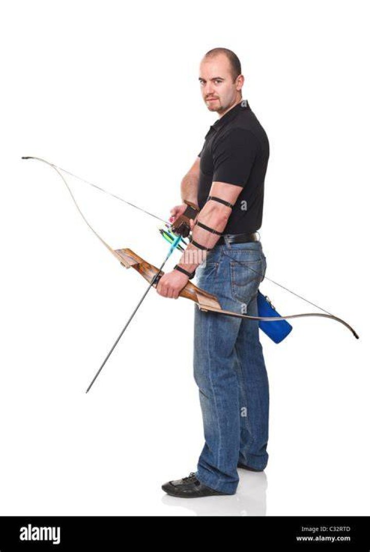 Man holding a bow and arrow on 'Naked and Afraid' Season 15