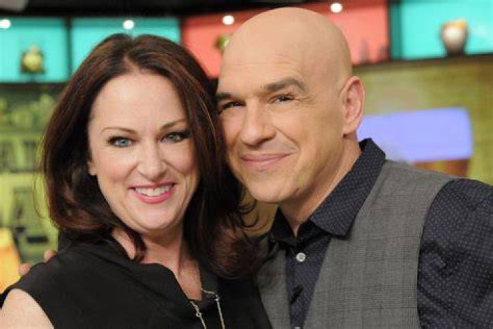Michael Symon and Liz Symon participate in a cooking demo. | Source: Getty Images