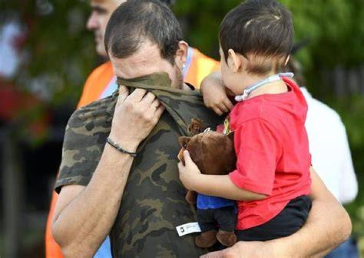 Nick Hurdakis holds his son, Alex Hurdakis. | Source: